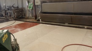 After the grout has dried, the Terrazzo Mechanic uses a terrazzo floor grinder to polish the floor up to 120 grit.